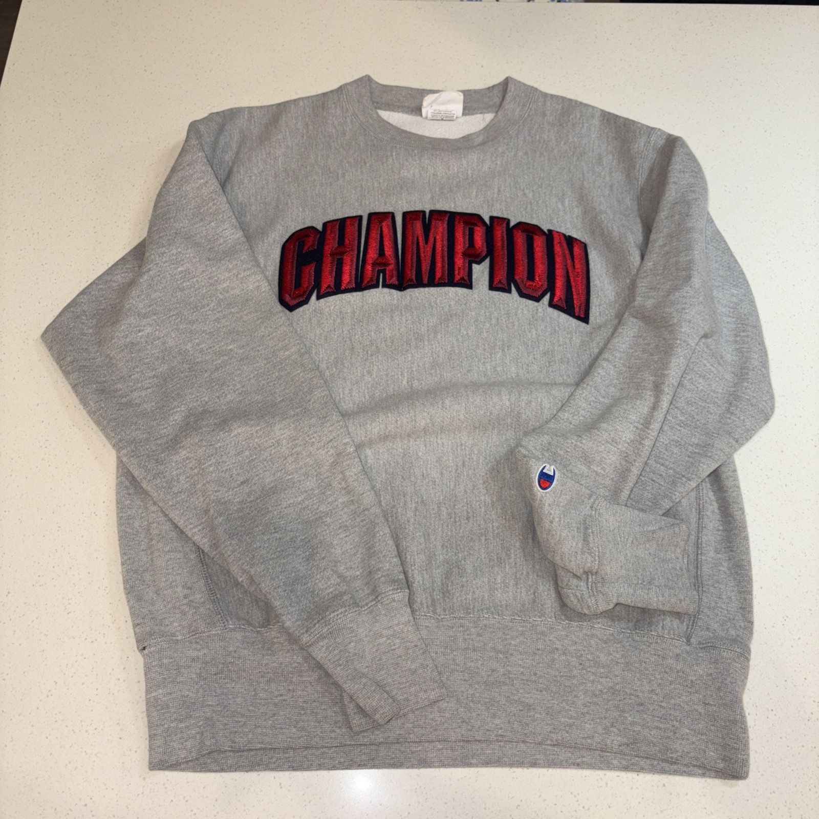 Men’s (M) Classic Stitched Champion Logo.