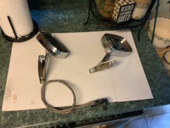 This is a vintage remote-control side-view mirror, likely for a 1970s General Motors vehicle, featuring a chrome finish and an attached https://offeru