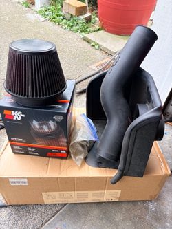 Toyota Tacoma 2020 High-performance K&N cold air intake system with a black plastic intake tube and 2 reusable conical air filter.