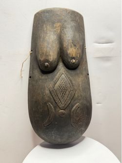 Such masks (known as *njorowe* or *ndimu*) are traditionally carved from a single piece of wood and represent a female torso—most often that of a preg