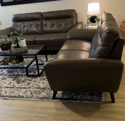 Gray leather sofa and loveseat combo