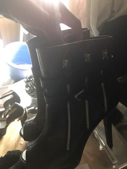 pair of black leather side zip heeled tip-toe sandals