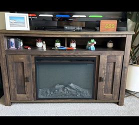 Wooden TV stand with electrical fireplace