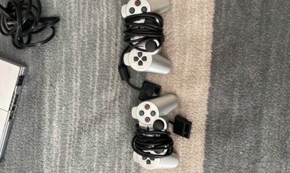 PlayStation 2 with controllers and cables