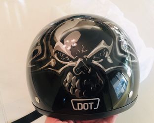 Motorcycle helmet - black with silver winged skulls.