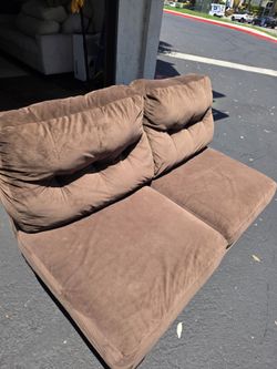 Brown armless sofa