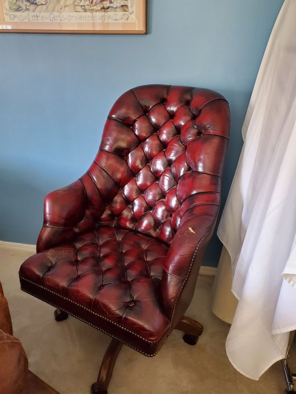 Leather office chair. Burgundy tear on left armrest. Works ...