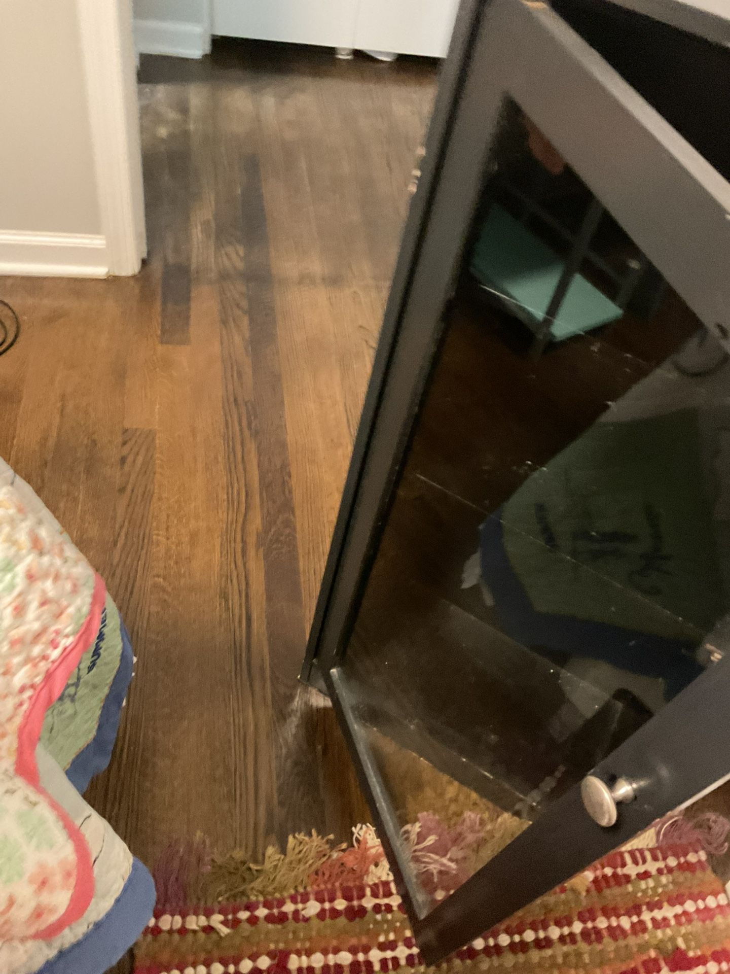 A Small Glass Door Cabinet With 3 Shelves Inside (18” Long X 9” Wide X  38” High)
