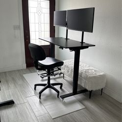 Adjustable work desk, two monitors, one adjustable chair.