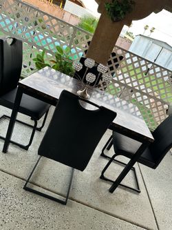 Dining table with 4 leather chairs.
