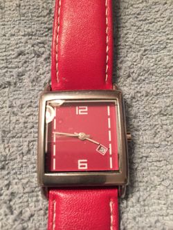 Silver tone watch with red face and leather band