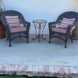 Two wicker chairs with marble top table