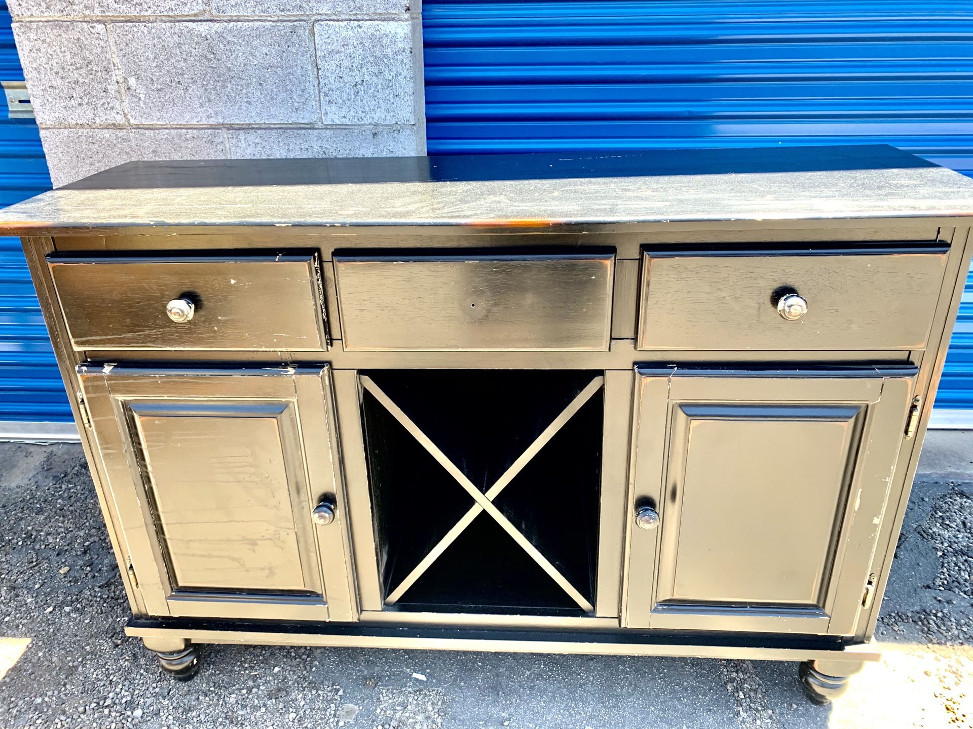 TV stand, buffet, black and reddish, nice condition. 3 pull drawers, two swing doors, center X shelves pull out