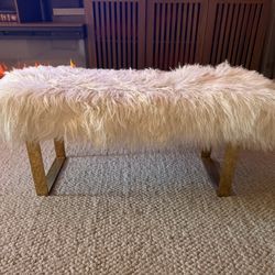 Bench with gold legs.