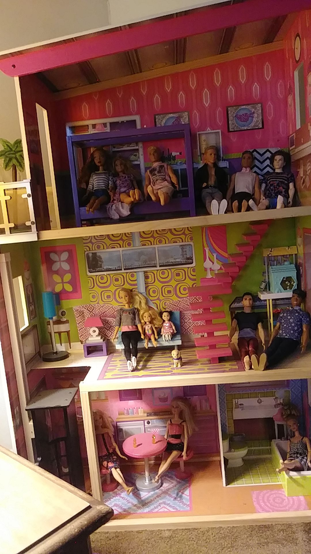 Three story barbie house with elevator that comes with 12 Barbie's and clothes and shoes.