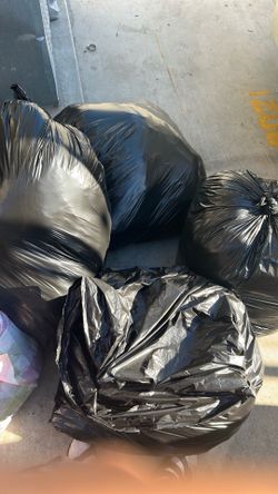 Bags of clothes like sweaters jeans and more