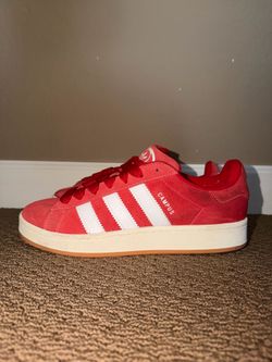 adidas Red Suede Low-Top Sneakers with White Stripes.