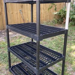 Plastic Shelf Rack H55”, W3ft, Deep2ft. 4 level shelf, 1 pole has different color from other set. In Boca Raton 
