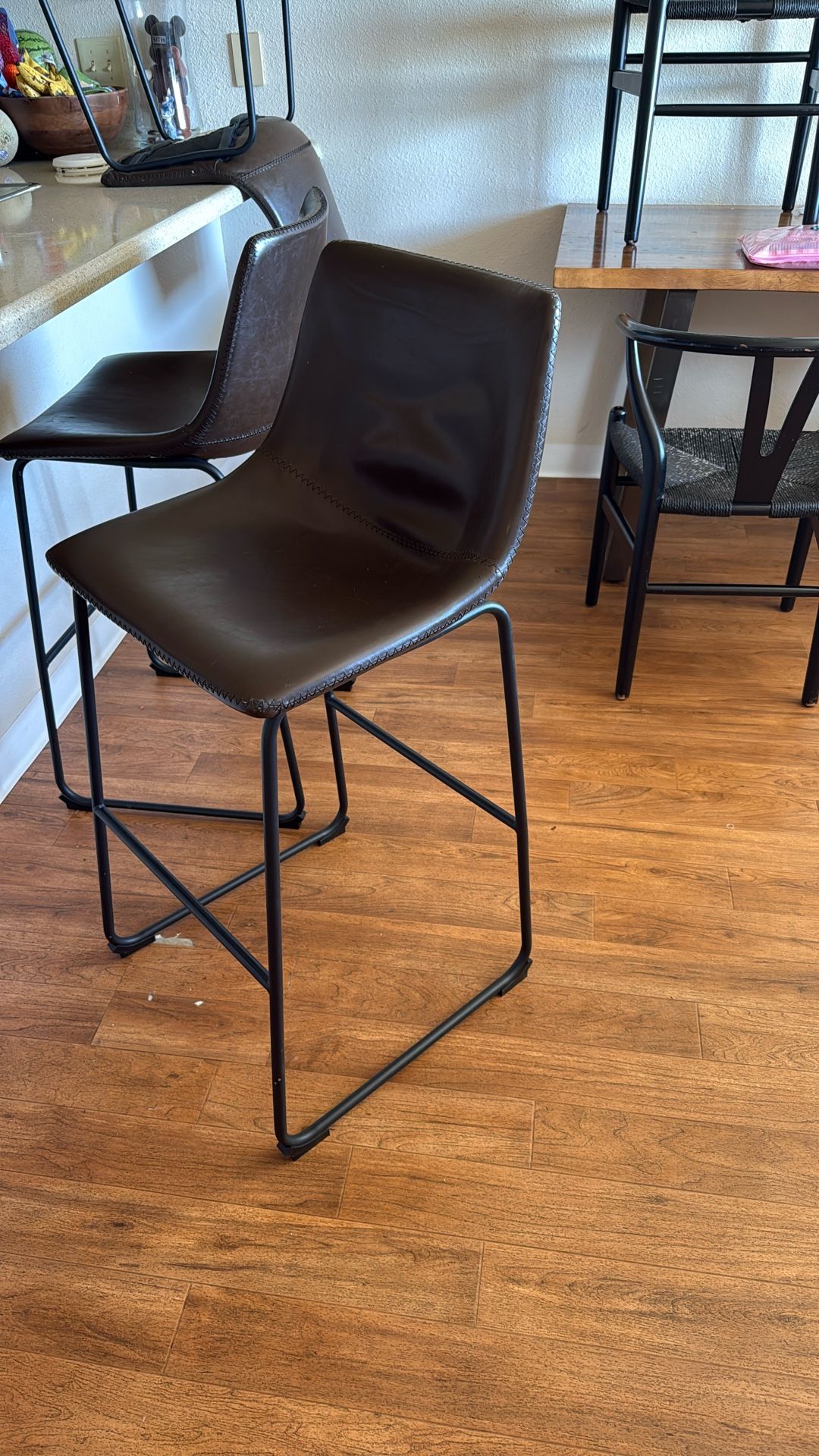 Three brown bar stools