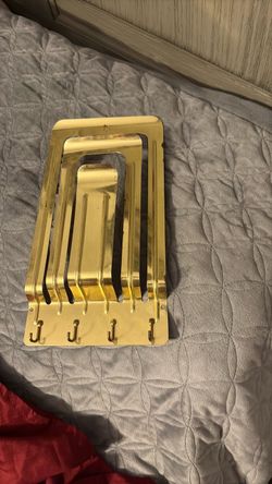 vintage brass-tone metal wall organizer with 4 hooks, possibly a mail or letter holder.