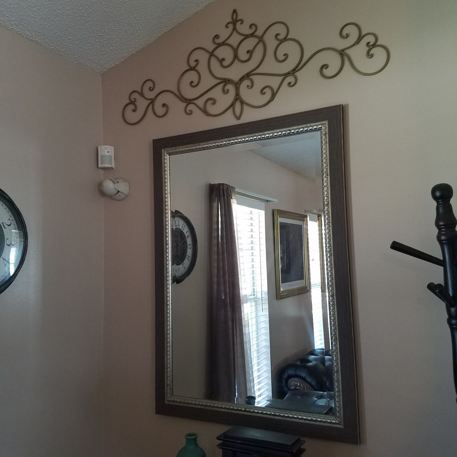 Silver mirror with silver metal wall decor