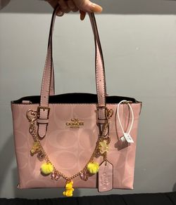 Pink coach purse with decoration