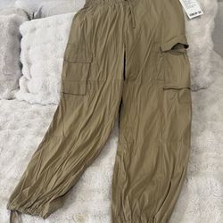 New Lululemon cargo pants. Khaki color. Size L. Has drawstring waist and ankles. Lots of pockets for your stuff.