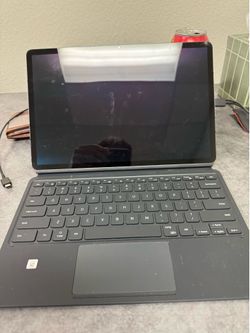 Samsung tablet with keyboard and charger .