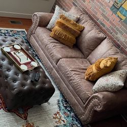 Sofa & ottoman with pillows.