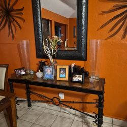 Large black beveled mirror with library table . Library table Is heavy steel and Beveled glass top.
