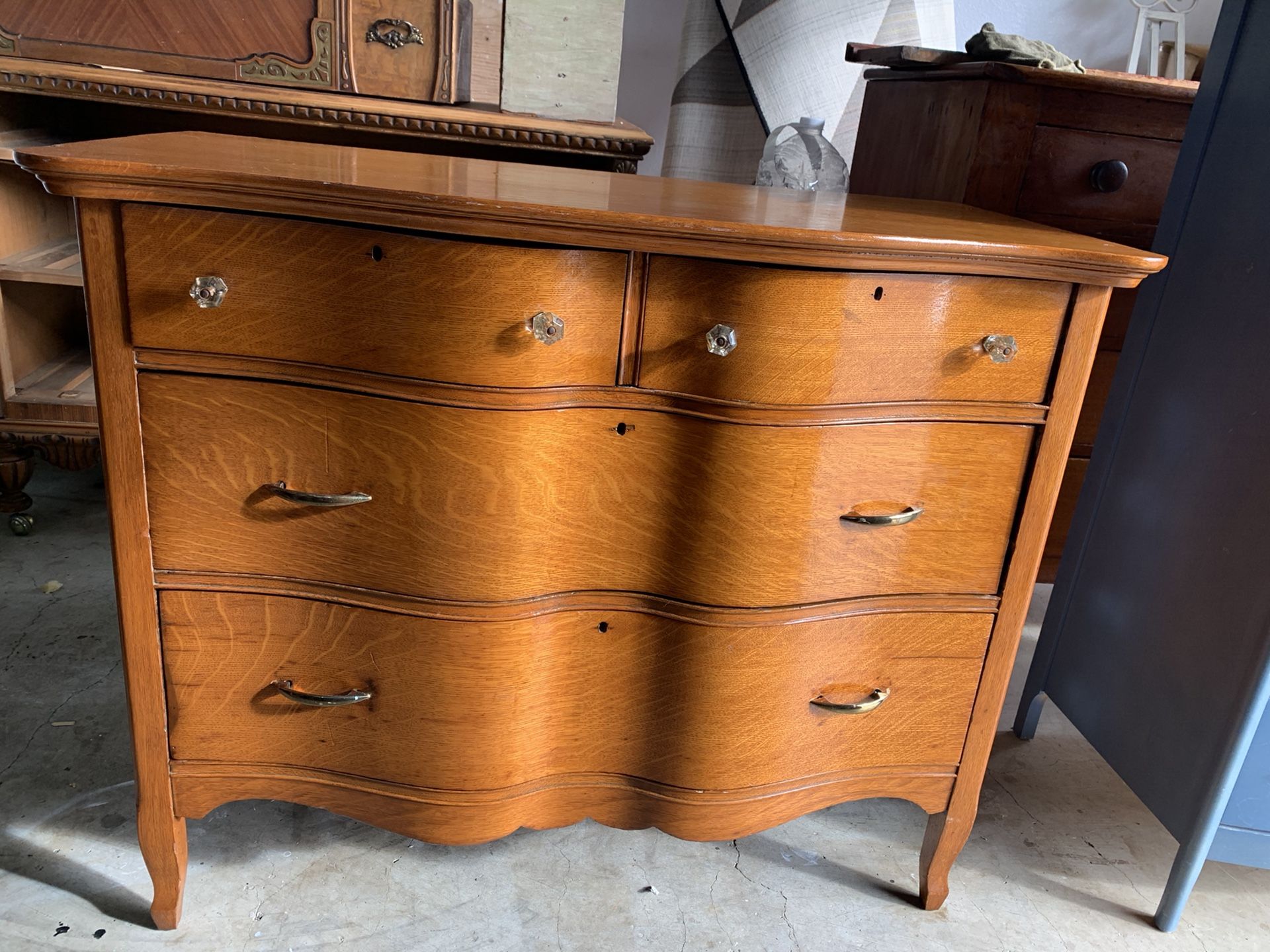 Antique solid oak serpentine dresser with antique glass knobs