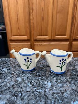 Vintage Shawnee Pottery 1940’s Watering Can Pair of Salt & Pepper Shakers.   Design Blue flower.  Size approximately 2 1/4 inches tall.  Stoppers have