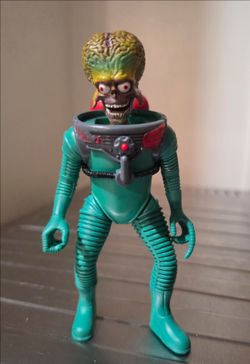 1996 Mars Attacks! Martian Trooper action figure released by Trendmasters.
features the iconic green-skinned alien with an exposed brain, skeletal gri