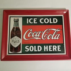 framed vintage-style metal sign for Coca-Cola.