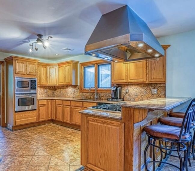 Wood Kitchen cabinets with granite stone ( includes sink, eat-in island ). Does not include appliances