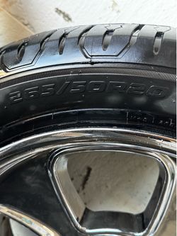 Set of chrome rims with tires .