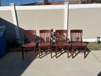 Four solid wood dining chairs