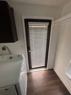 Modern Black Framed Glass Exterior Door with Built-In Blinds