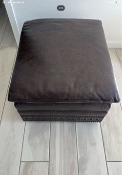 Leather storage ottoman.