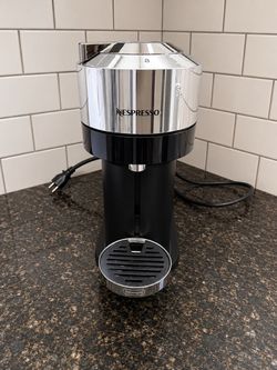 Nespresso Vertuo Next Deluxe coffee machine chrome and black finish.
