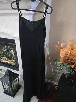 Classic black slip maxi with a V-neckline. Thin adjustable spaghetti straps. Smooth, drapey silhouette for easy layering or solo wear. Size M. Very sm