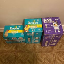 Two Boxes Of Pampers And One Box Of Luvs