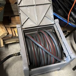 Grey garden hose dispenser with 100 ft hose in