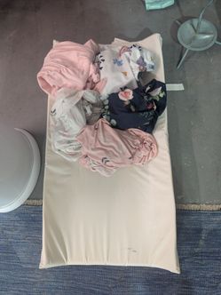 Soft Changing table pad with several clean fitted sheets for girls. good condition