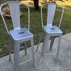 two aluminum chairs were put by the pool no need for them 