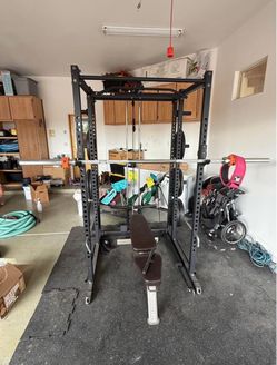 Power Rack with Barbell and Weight Plates and treadmill