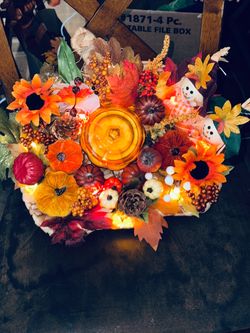Holiday wreaths and tabletop decor with candle.