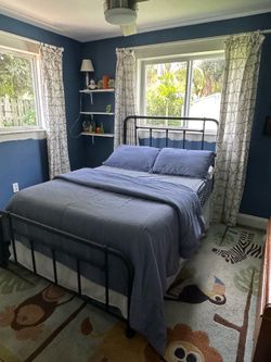 Full size black metal bed with mattress and box spring