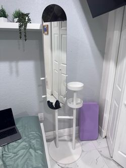 Standing jewelry armoire with a full-length mirror