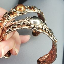 Silver And Copper Bracelets.